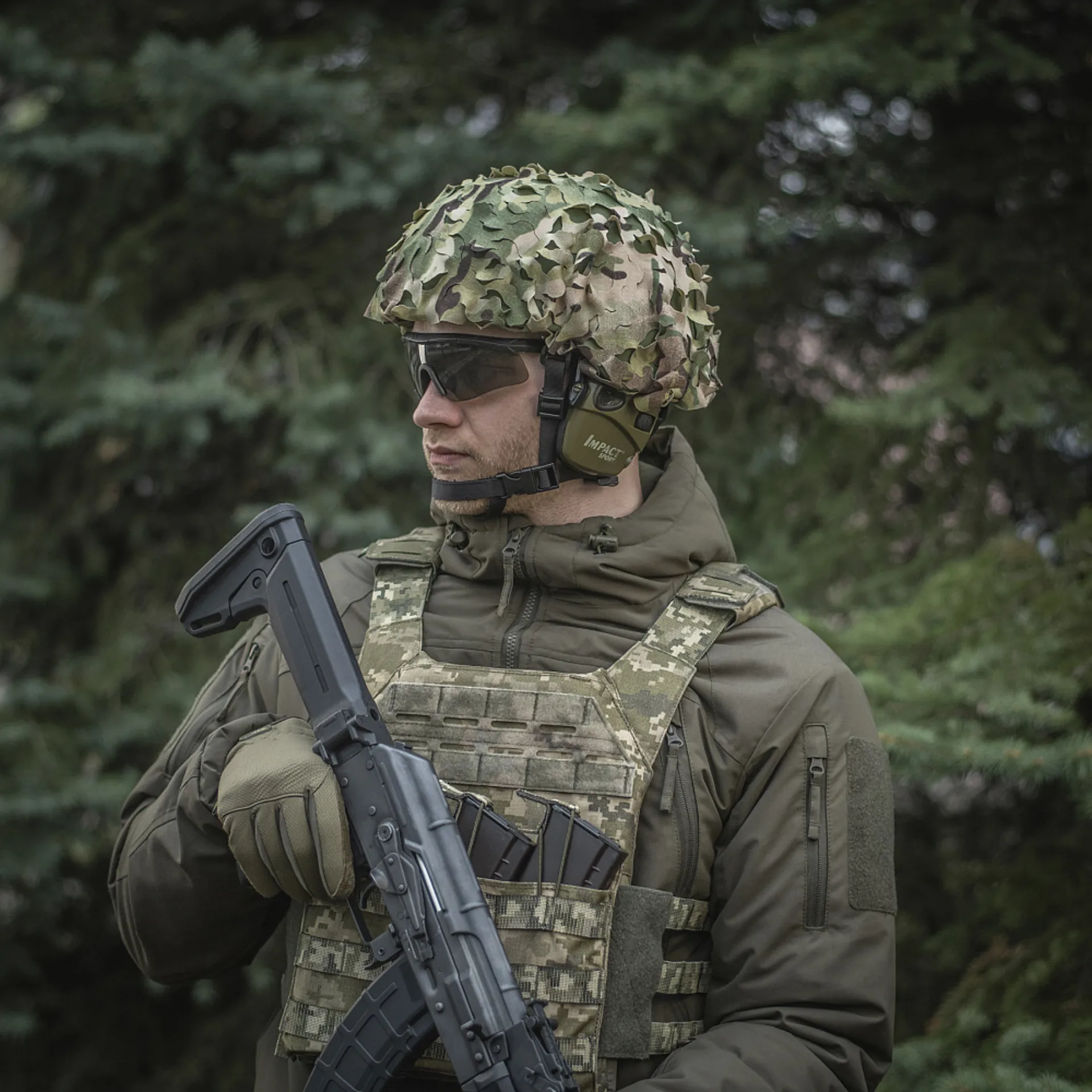 man in military gear and camouflage pattern with airsoft gun